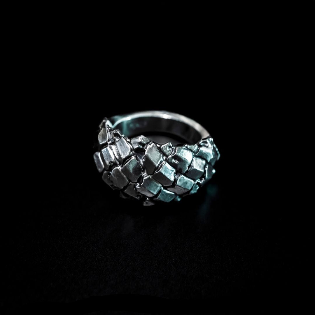 silver ring with abstract flowing plates sculpted across the form