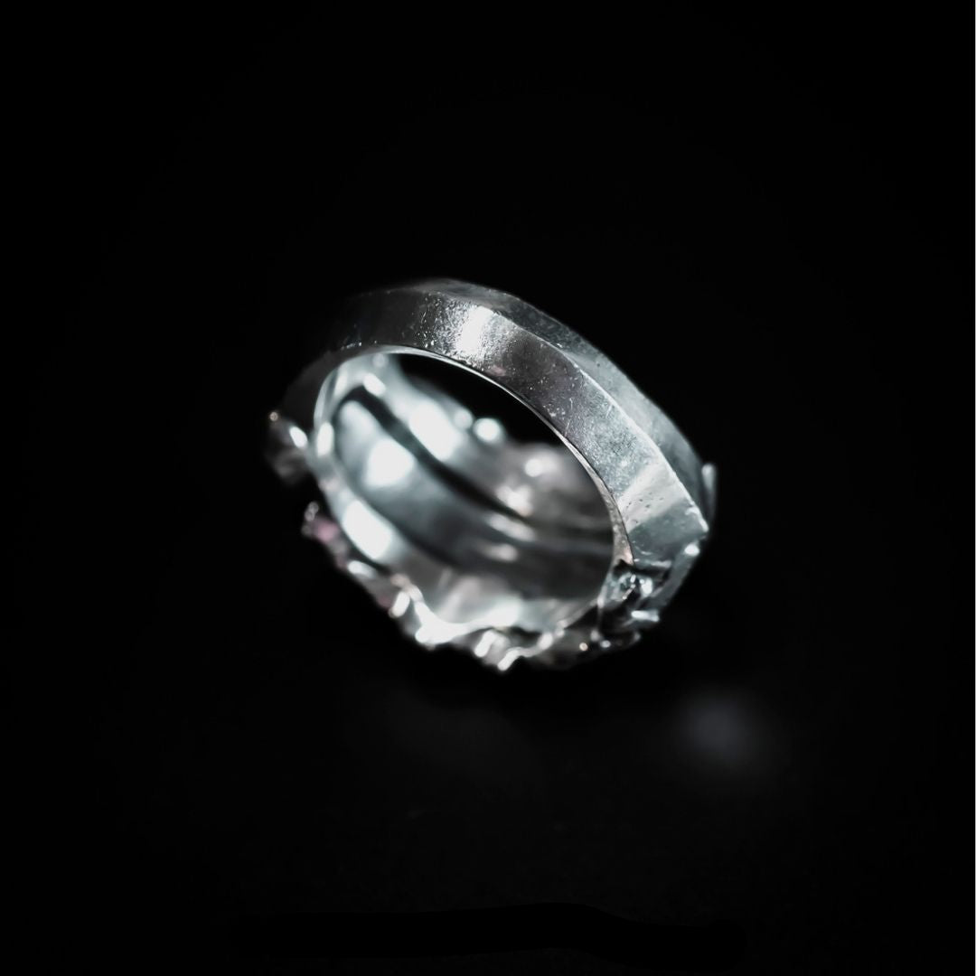 silver ring with abstract flowing plates sculpted across the form