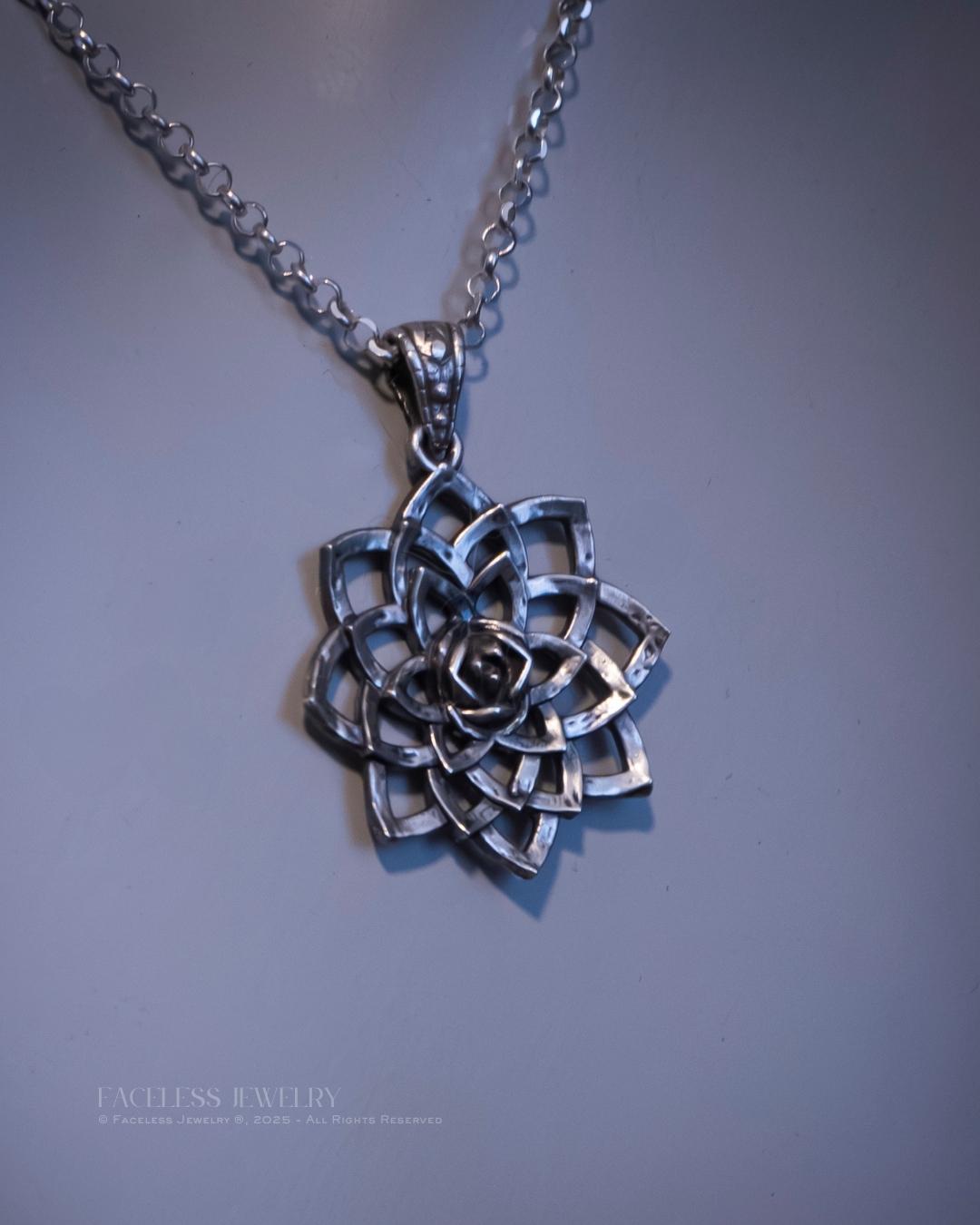 Silver floral pendant necklace on a gray background
