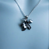 Silver necklace with a butterfly pendant on a light gray background