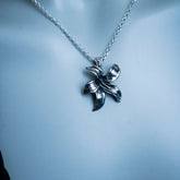 Silver necklace with a leaf-shaped pendant on a mannequin.