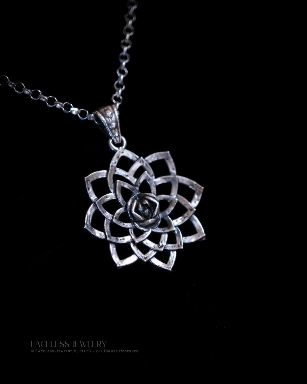 Silver lotus flower pendant on a black background