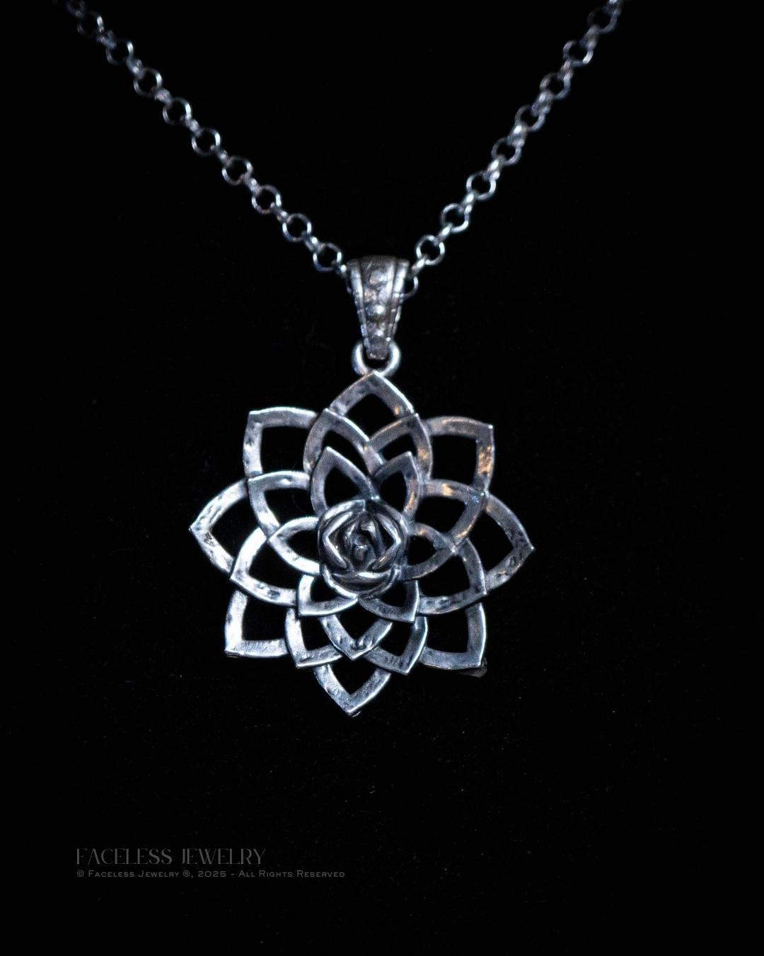 Silver lotus flower pendant on a black background with &