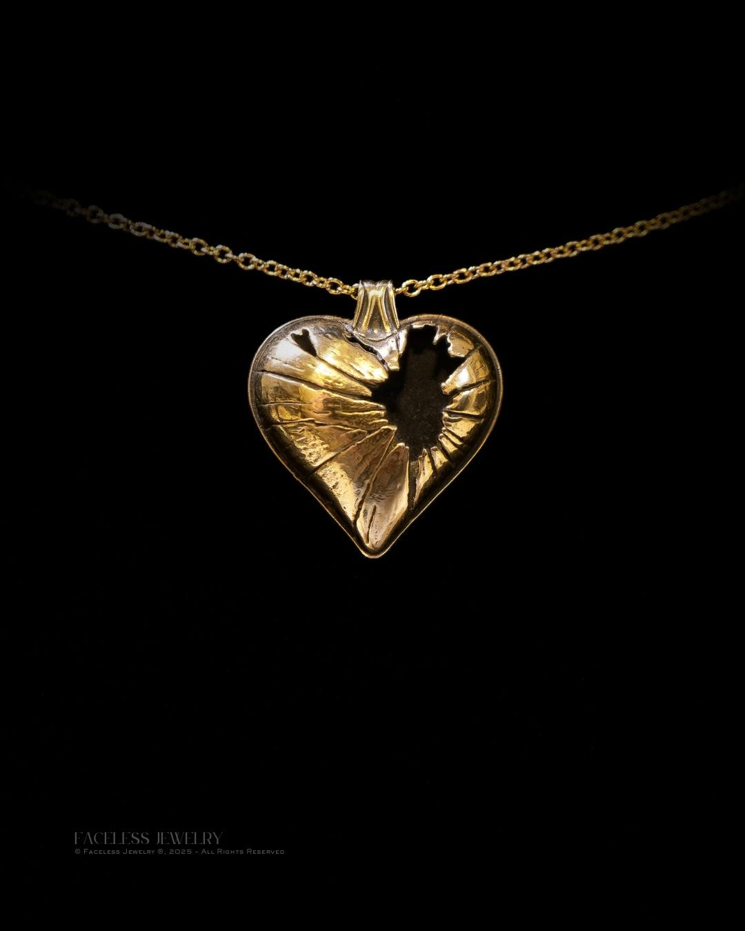 Gold heart-shaped pendant necklace on a black background
