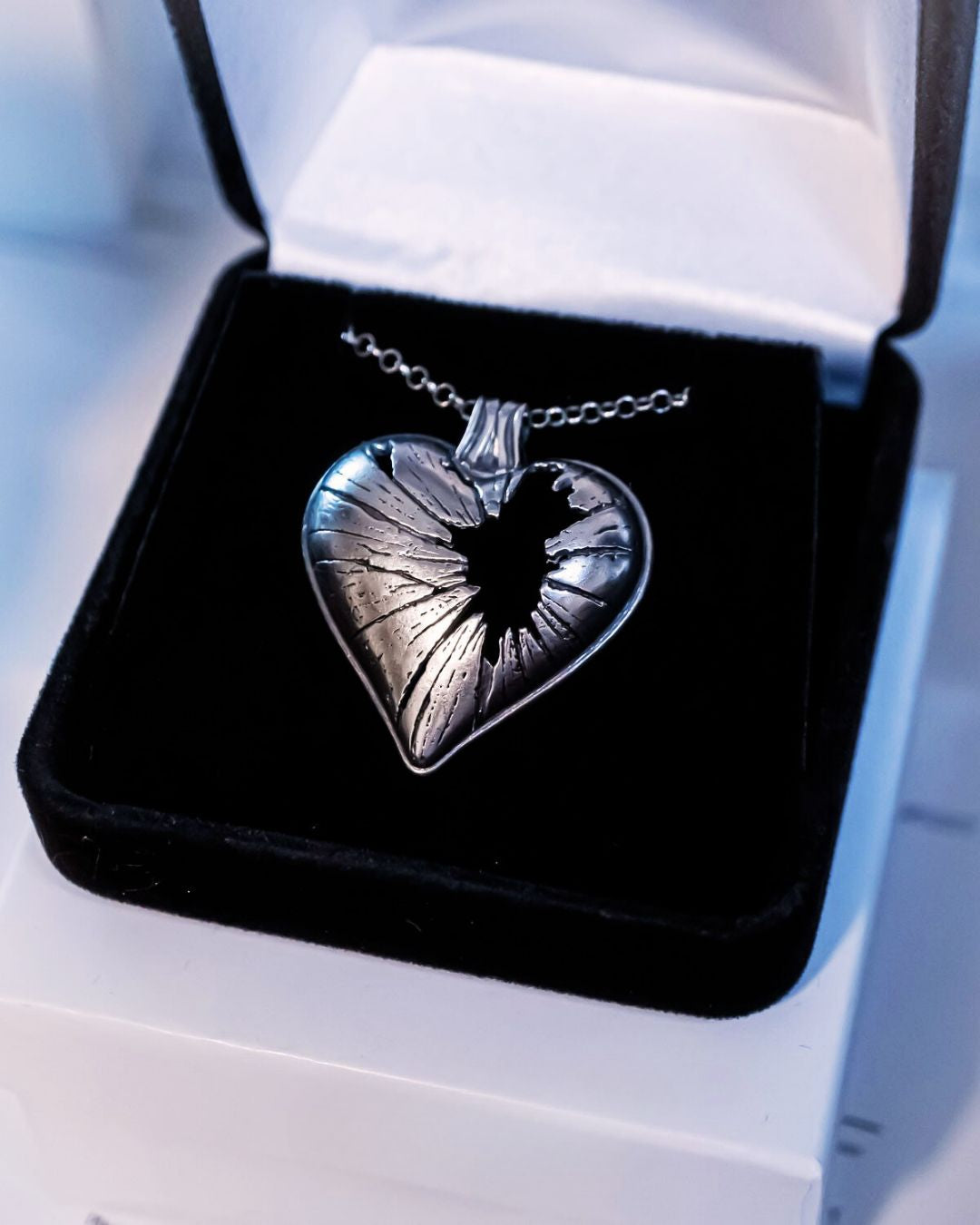 Heart-shaped pendant necklace in a black velvet box